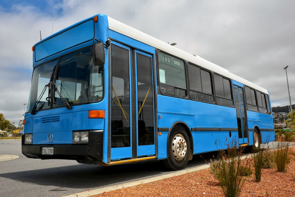 A large blue 45 seat Mercedes coach