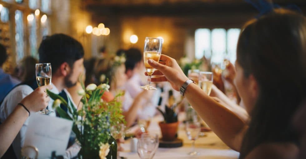 Champagne glasses raised at a function